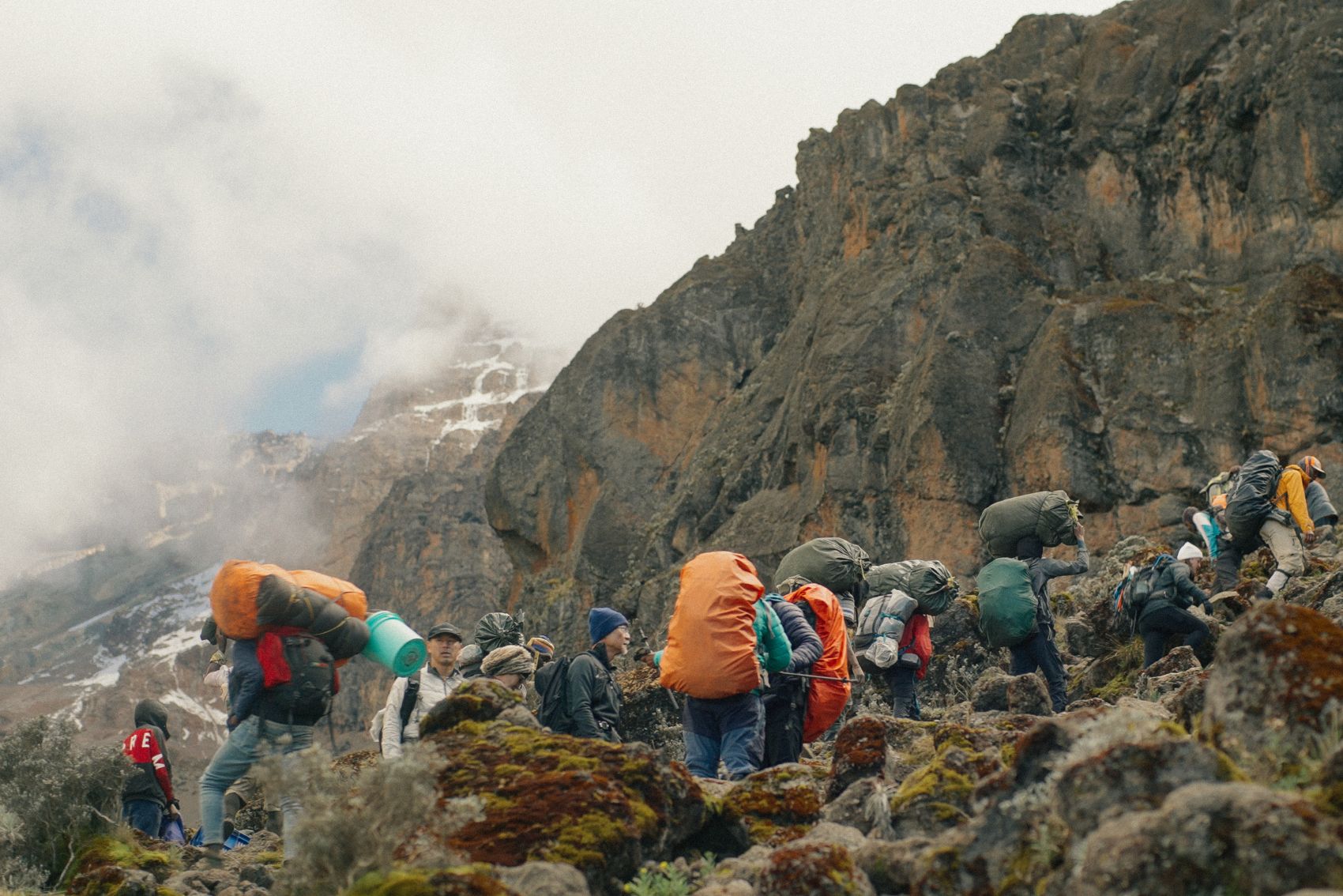 People trekking with their backpacks on Mt. Kilimanjaro in Tanzania