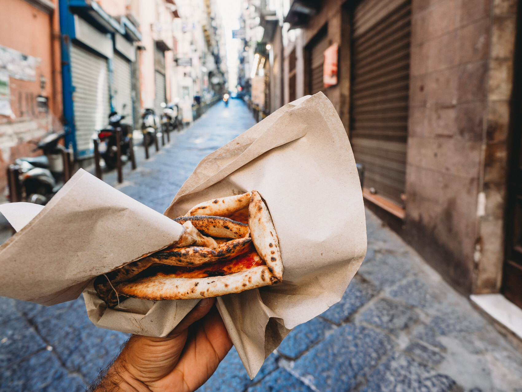 View of a man eating a typical "Pizza a portafoglio" in Naples, Italy &mdash; FilippoBacci