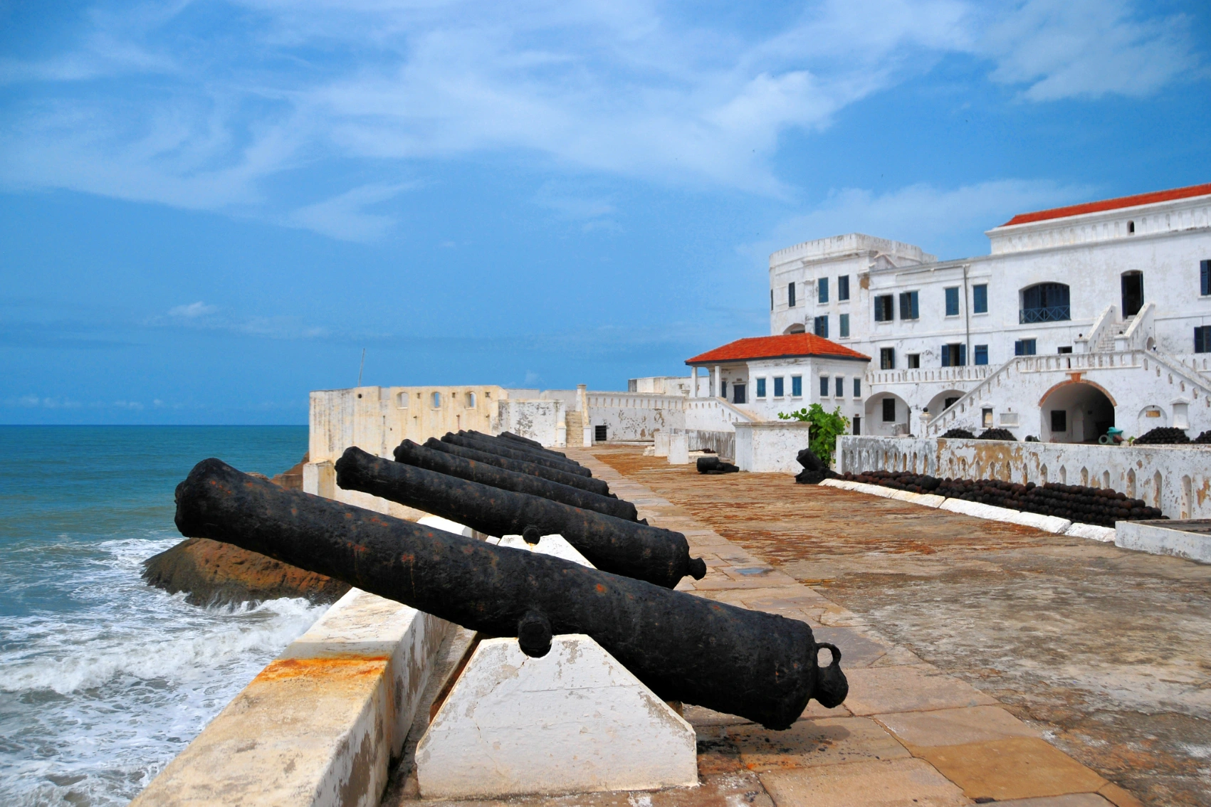 Historic cannons point out to see on the ramparts of Cape Coast Castle in Ghana
