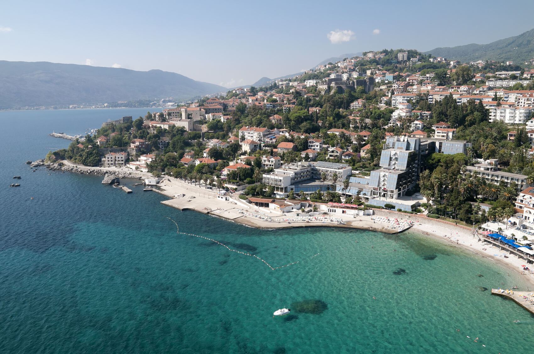 An aerial view of the beach, sea, and town of Herceg Novi in Montenegro