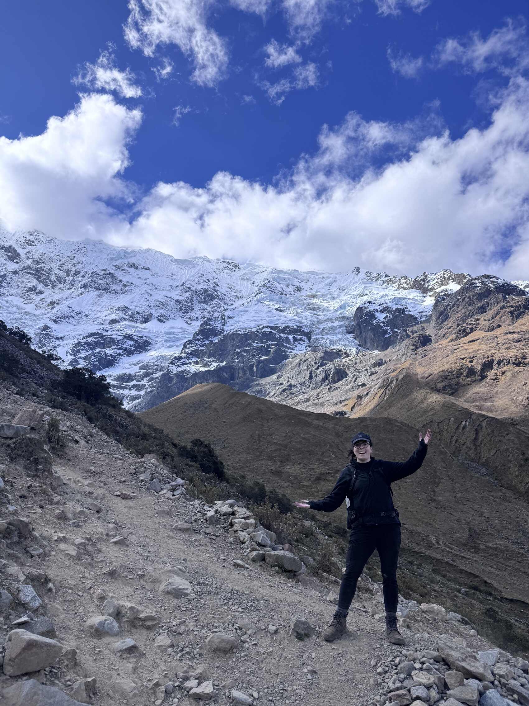 Traveller Jordan LoMonaco standing on a mountain pass on the Salkantay Trek in Peru
