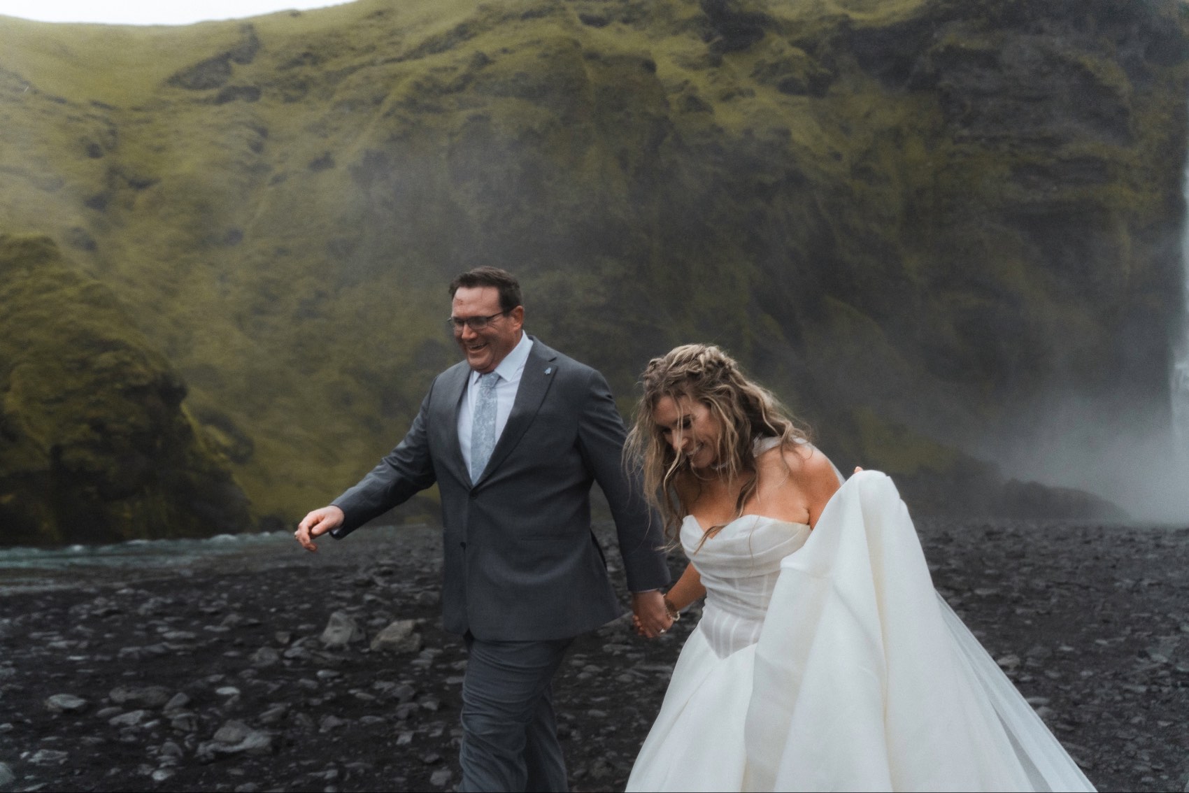 Married couple The Ponds walking on the beach in Iceland