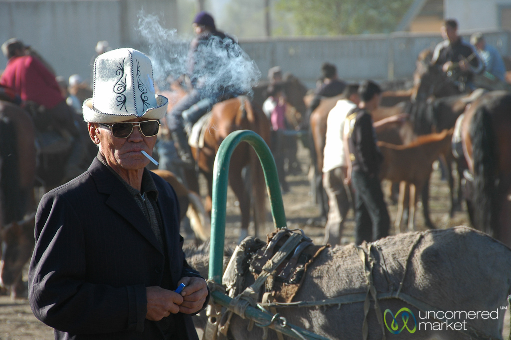 A Kyrgyz man in a traditional hat — kalpak — at the animal market.