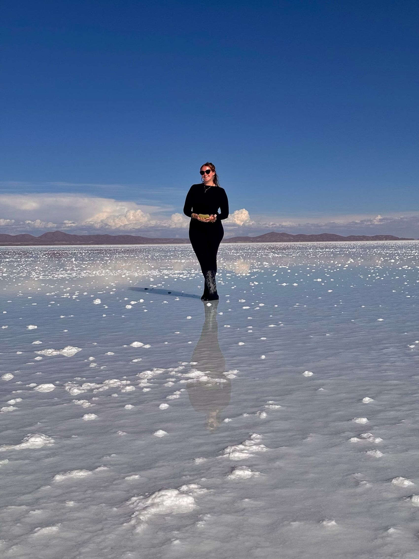Katy Rix posing for a photograph on the Bolivian Salt Flats in South America