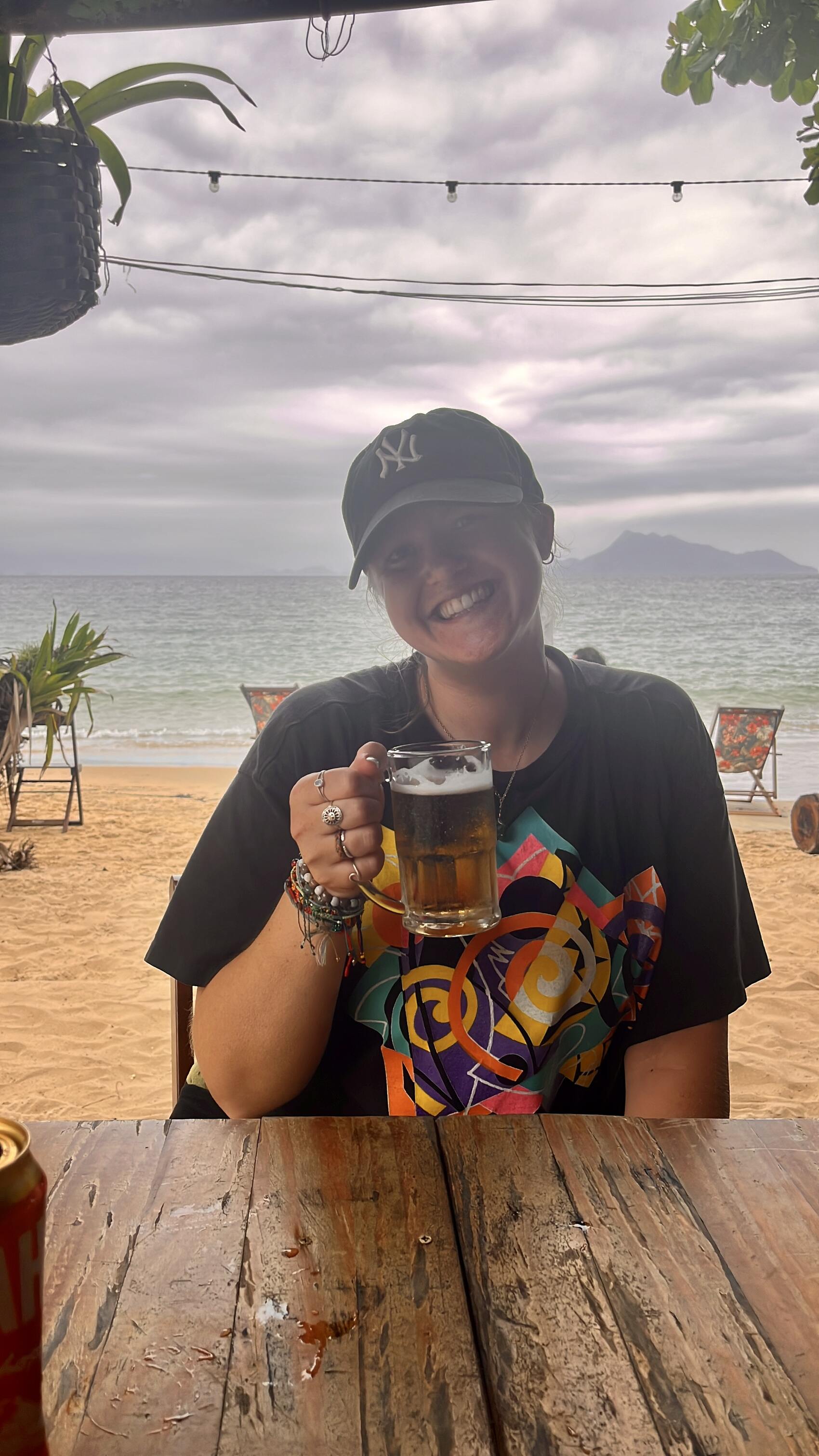 Katy Rix posing with a beer in South America