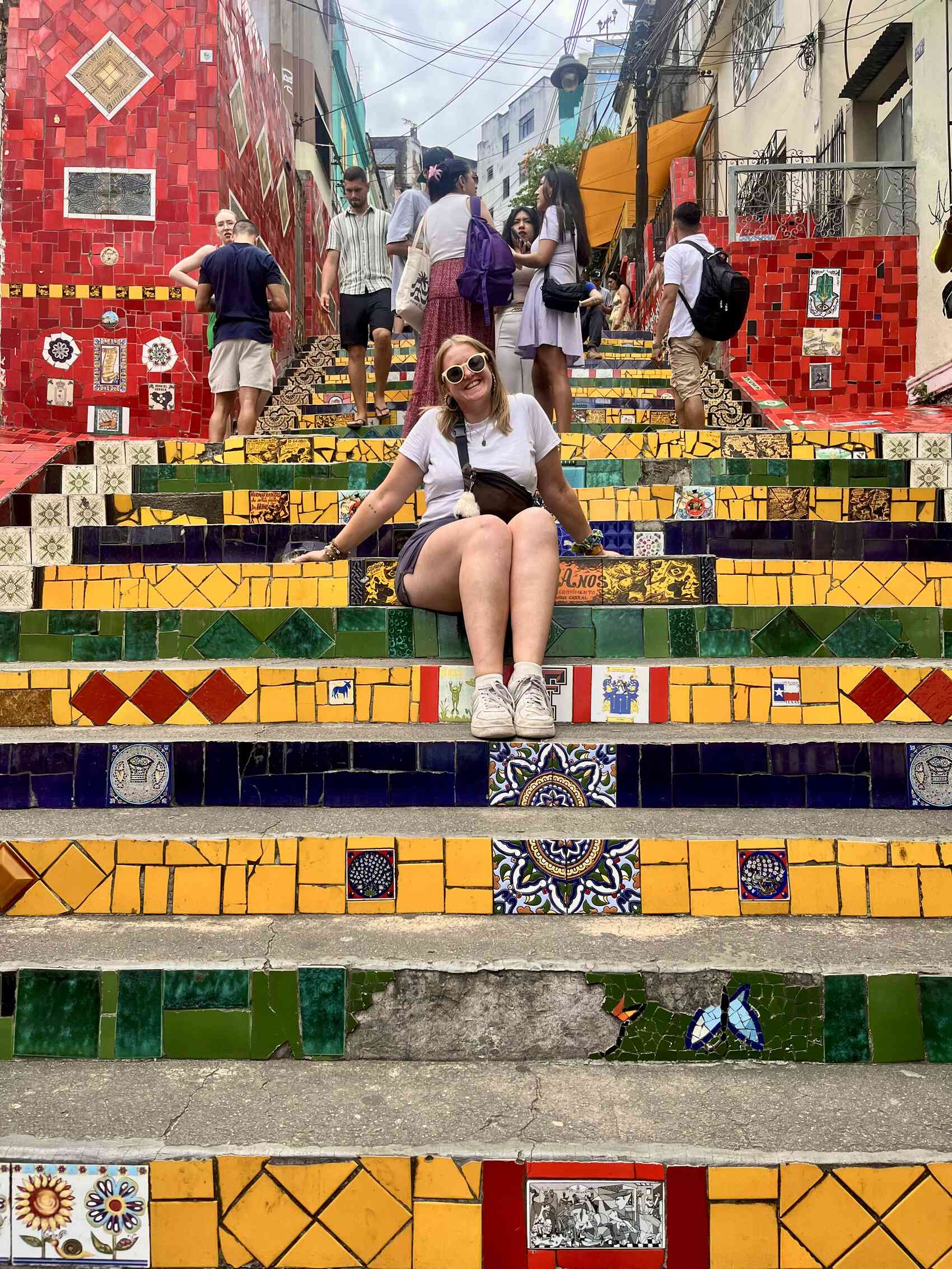 Katy Rix sitting on the Escadaria Selarón in Lapa, Rio de Janeiro, Brazil