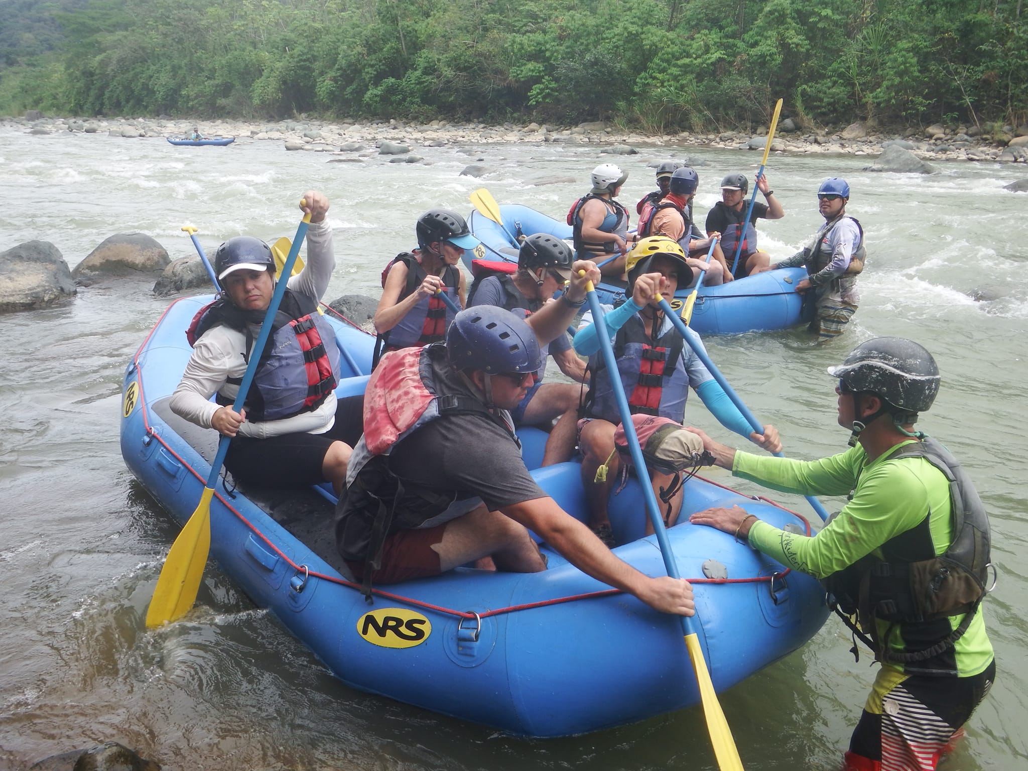 A group of travellers white water rafting in Costa Rica