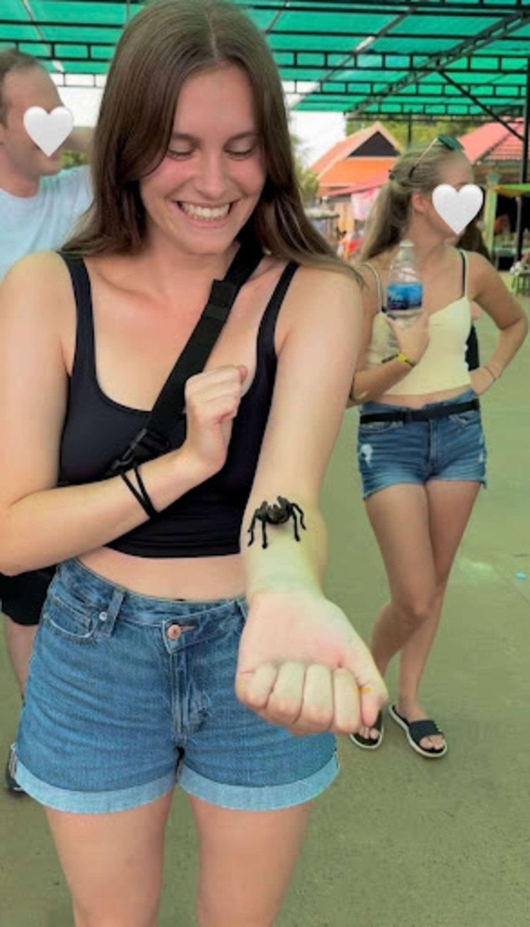 Swiss traveller Michelle Meyer holding a tarantula in Vietnam on a G Adventures trip