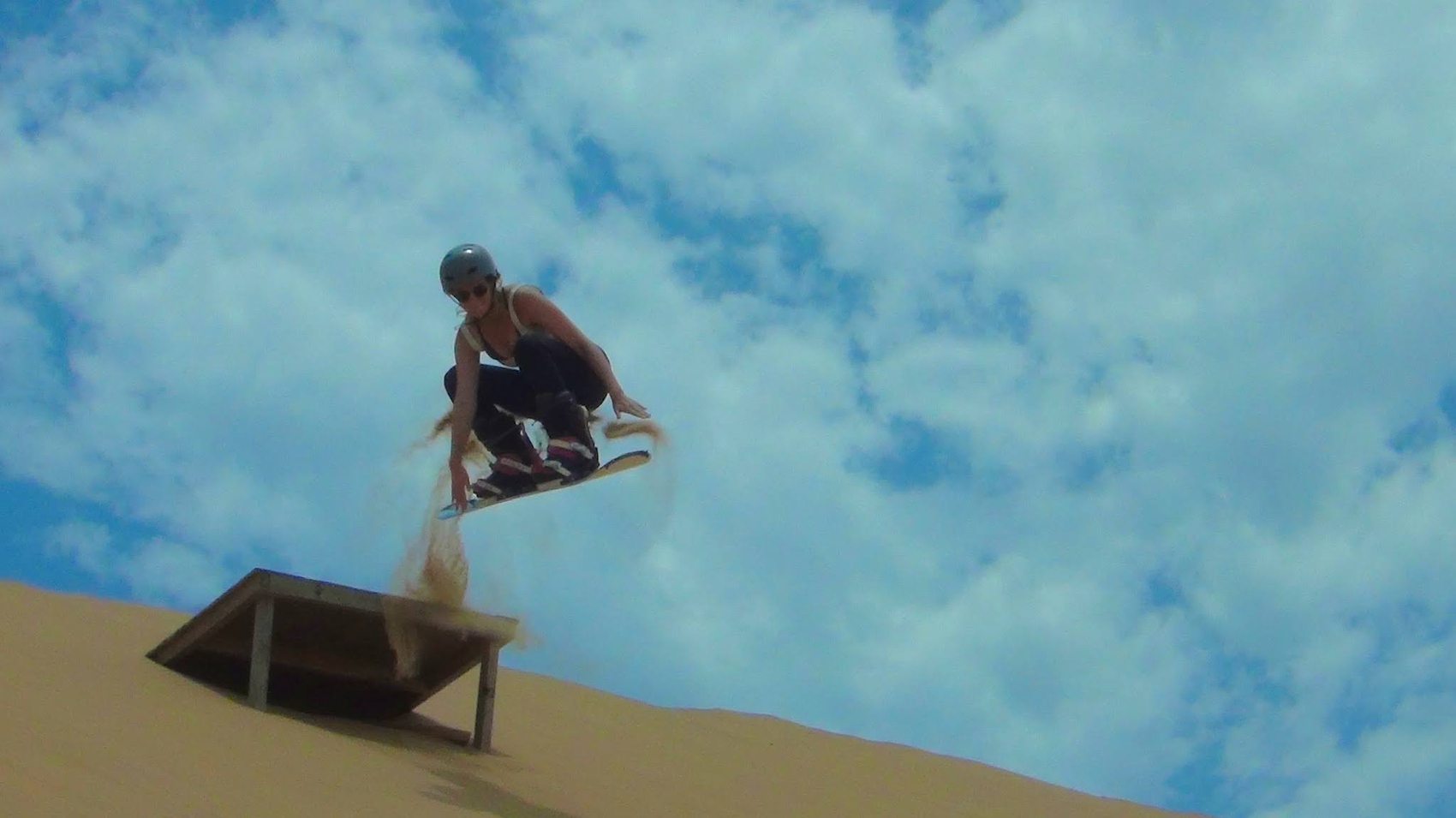 Swiss traveller Michelle Meyer sandboarding on a G Adventures trip