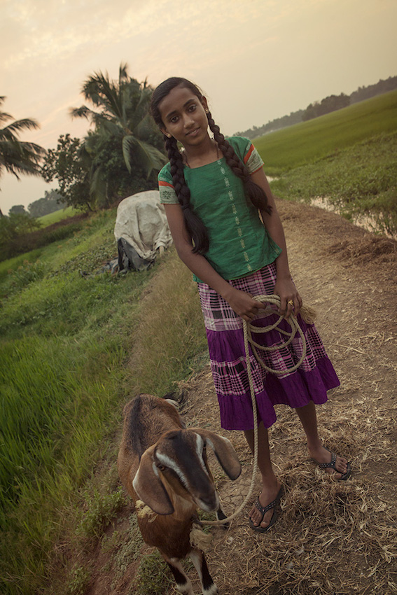 A girl and her goat pose for the camera.