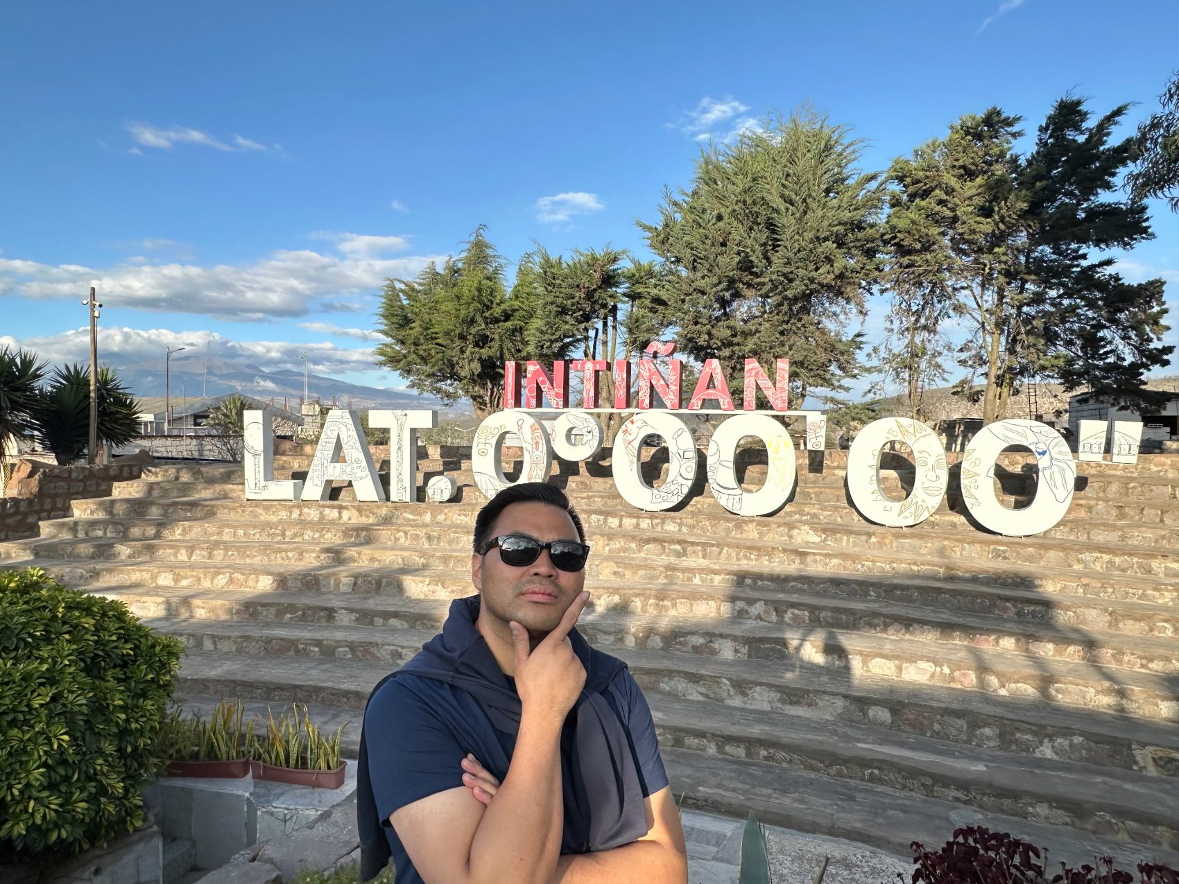 Reginald Ramirez standing in front of the Equator in the Gal&aacute;pagos Islands