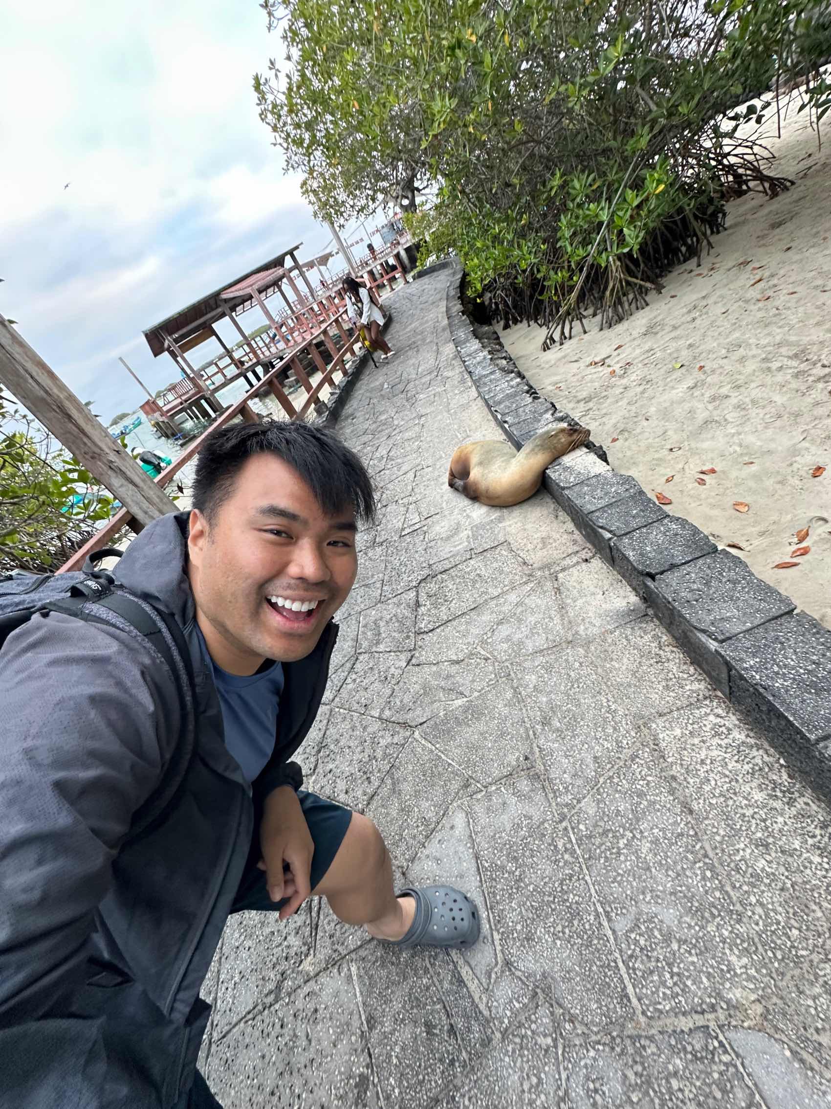 Reginald standing in front of a sleeping sealion in the Gal&aacute;pagos