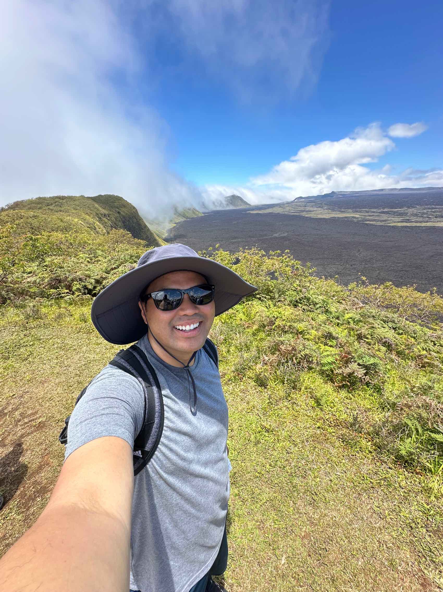 Reginald taking a photograph in front  of greenery in the Gal&aacute;pagos Islands