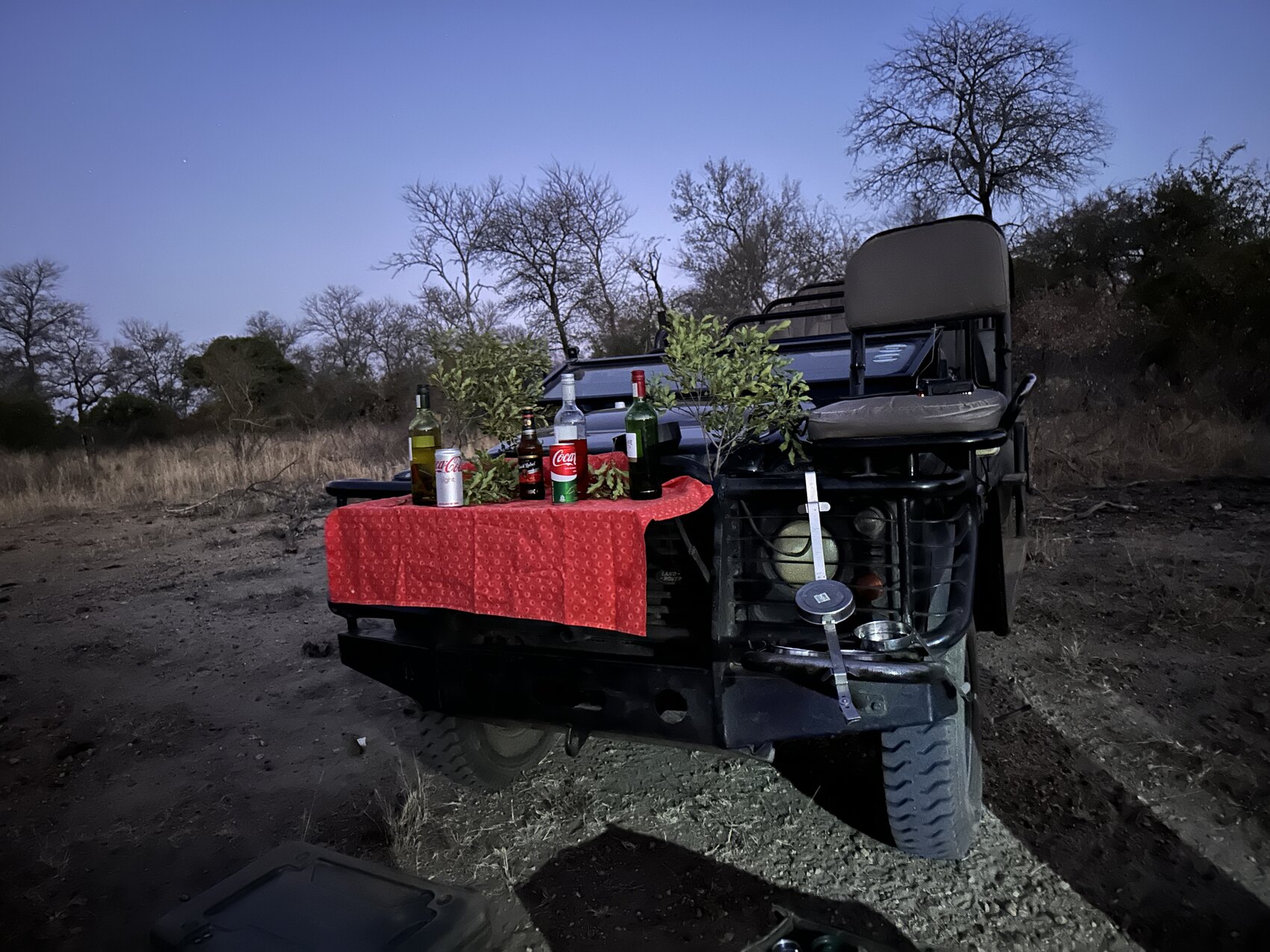 A safari vehicle with a spread of sundowner drinks