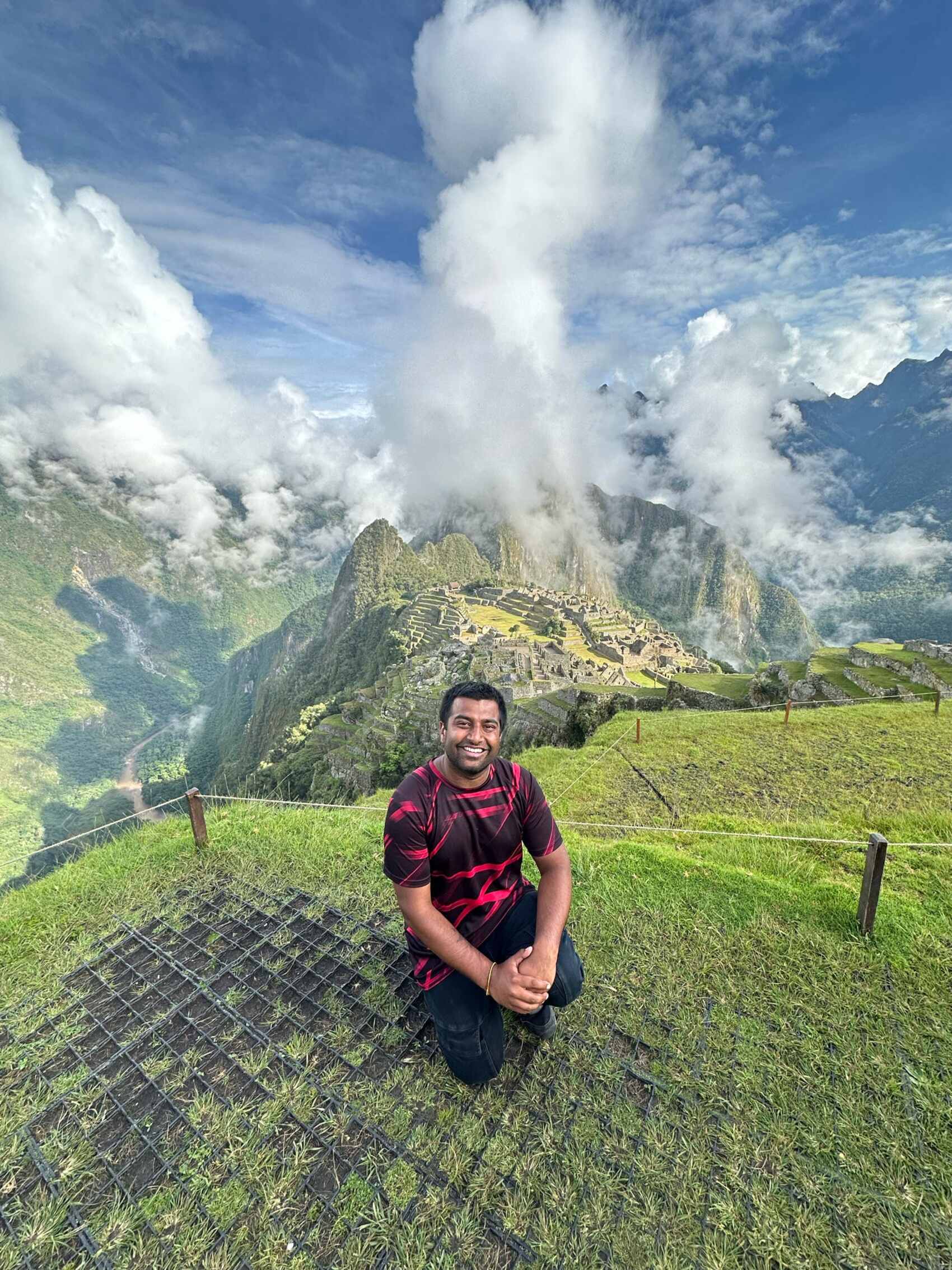 Ritesh Maharaj posing for a picture in front of Machu Picchu in Peru