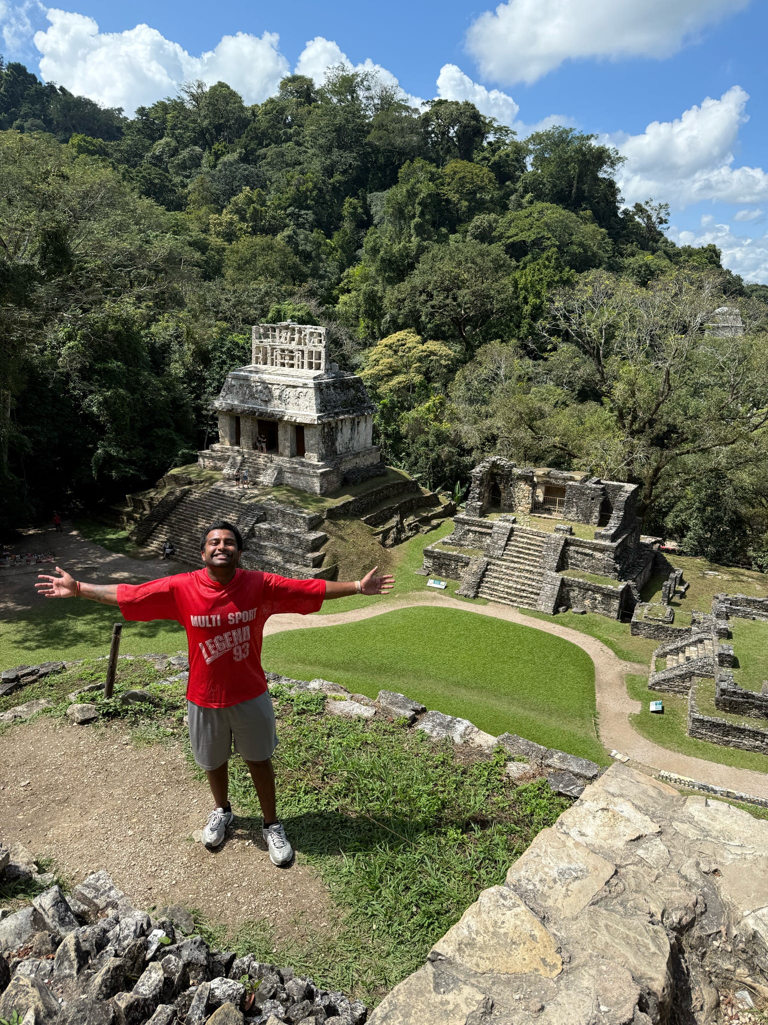 Traveller Ritesh standing in front of some Maya ruins in Central America
