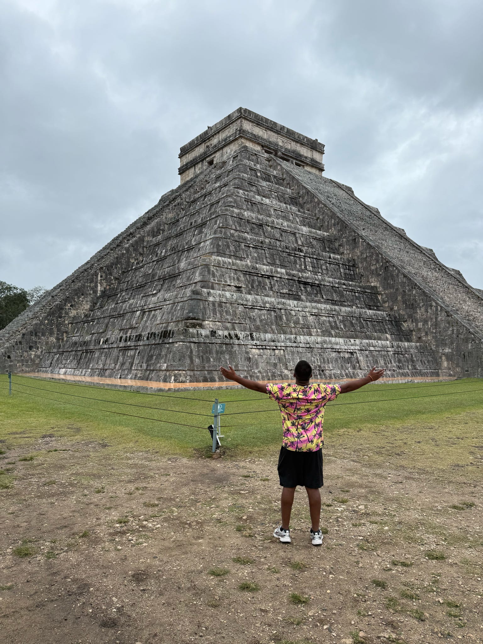 Traveller Ritesh posing for a photograph in front of an ancient Maya pyramid in Mexico